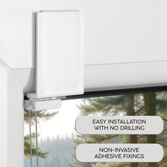 Window blind with adhesive strip on a glass door, showing installation text.