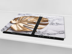 Induction Cooktop Cover Kitchen Board – Impact Resistant Glass Pastry Board – Heat resistant; MEASURES: SINGLE: 60 x 52 cm (23,62” x 20,47”); DOUBLE: 30 x 52 cm (11,81” x 20,47”); D31 Tropical Leaves Series: Golden leaf on marble