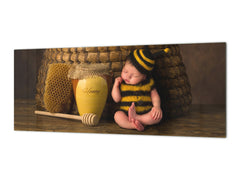 Wide-format tempered glass kitchen wall panel with metal backing - and without: Sleepy  baby in bee outfit