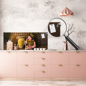 Wide-format tempered glass kitchen wall panel with metal backing - and without: Sleepy  baby in bee outfit